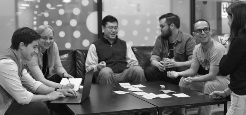 Image of a group of employees collaborating. I'm the man in yellow T-shirt.
